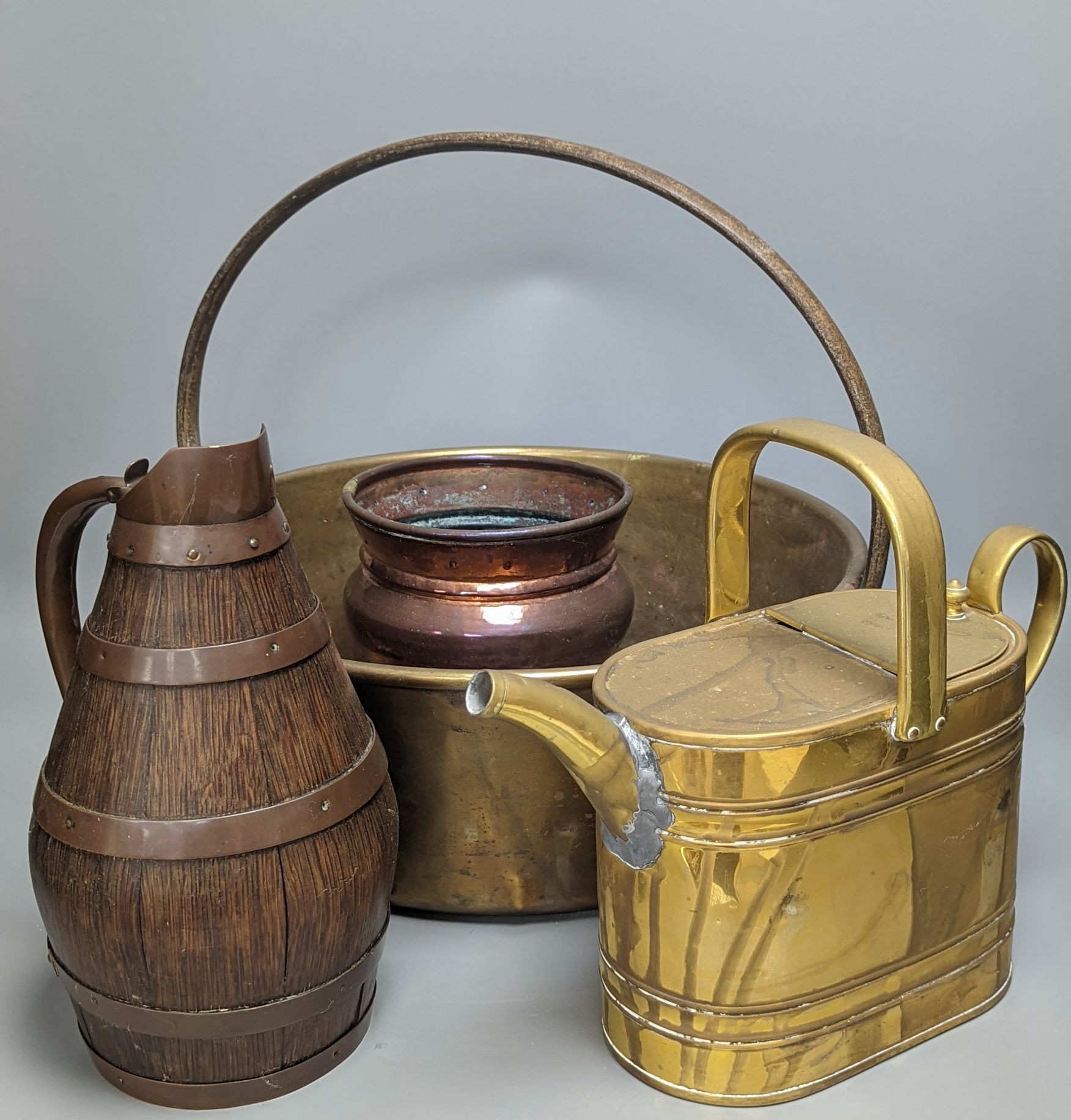 A studded copper pail, a coopered oak jug and other copper and brass wares, coopered jug 28cm high